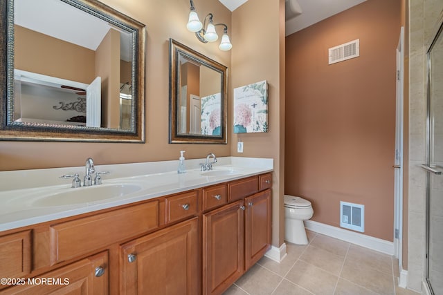 bathroom featuring vanity, toilet, an enclosed shower, and tile patterned flooring