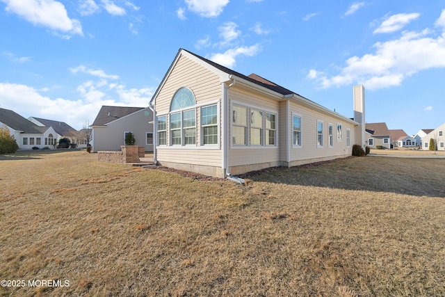 view of property exterior with a lawn