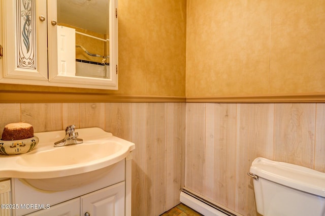 bathroom featuring vanity, baseboard heating, and toilet