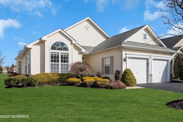 view of front facade with a front yard and a garage