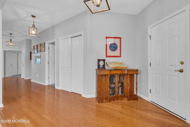 entrance foyer featuring an inviting chandelier and wood-type flooring