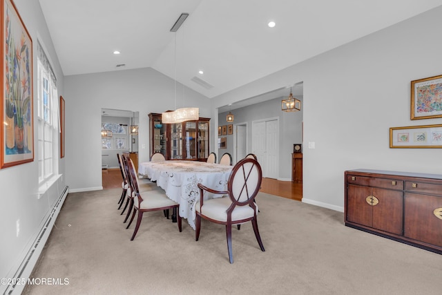 carpeted dining area featuring vaulted ceiling and a baseboard heating unit