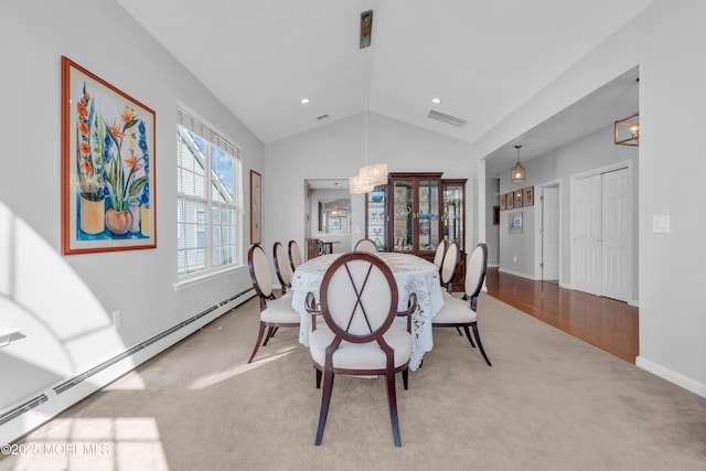 dining room featuring baseboard heating, light carpet, and lofted ceiling