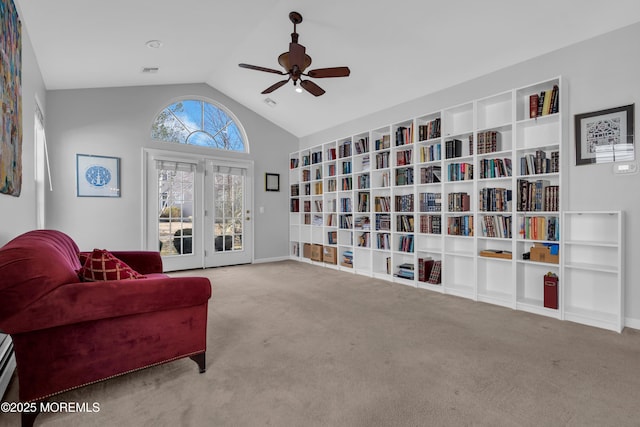 living area with carpet floors, lofted ceiling, built in shelves, and ceiling fan