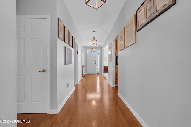 corridor with light hardwood / wood-style flooring