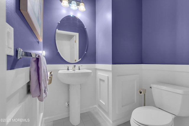 bathroom featuring toilet and tile patterned flooring