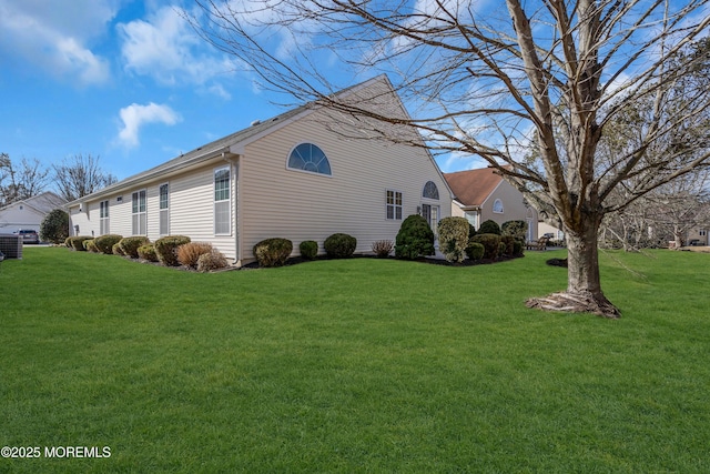 view of side of home featuring a yard