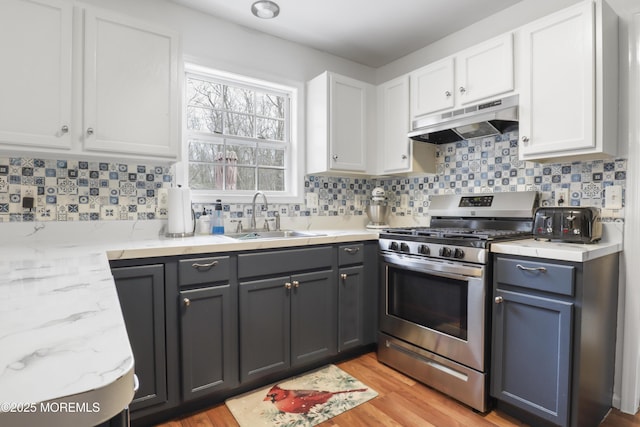 657 Toms River Rd, Jackson, NJ 08527 - kitchen featuring under cabinet range hood, white cabinets, a sink, and stainless steel gas range