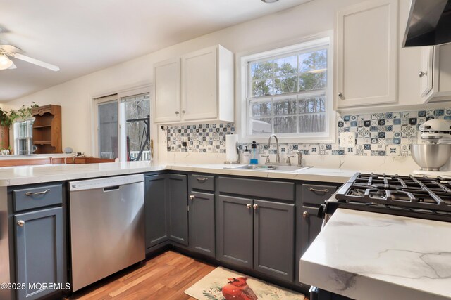 657 Toms River Rd, Jackson, NJ 08527 - kitchen with dishwasher, wall chimney exhaust hood, a ceiling fan, a sink, and gray cabinets