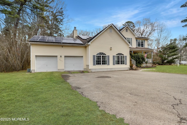 657 Toms River Rd, Jackson, NJ 08527 - traditional-style house with a garage, driveway, solar panels, and a front lawn