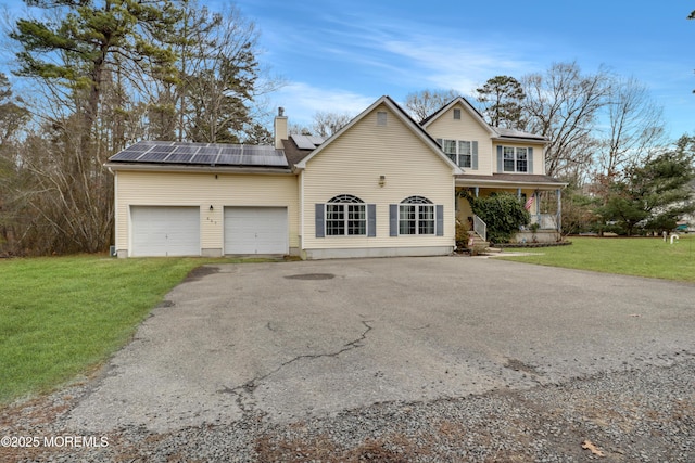 657 Toms River Rd, Jackson, NJ 08527 - traditional-style home with aphalt driveway, an attached garage, a chimney, a front lawn, and covered porch