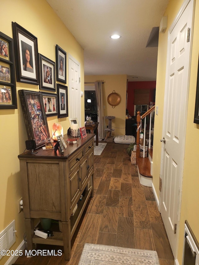 hall with dark hardwood / wood-style flooring