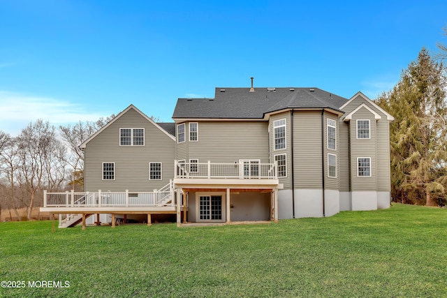 rear view of property featuring a deck and a lawn