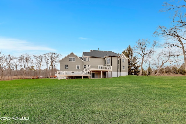 rear view of property featuring a wooden deck and a lawn