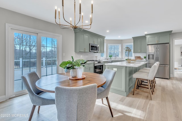 dining room featuring sink and light hardwood / wood-style floors