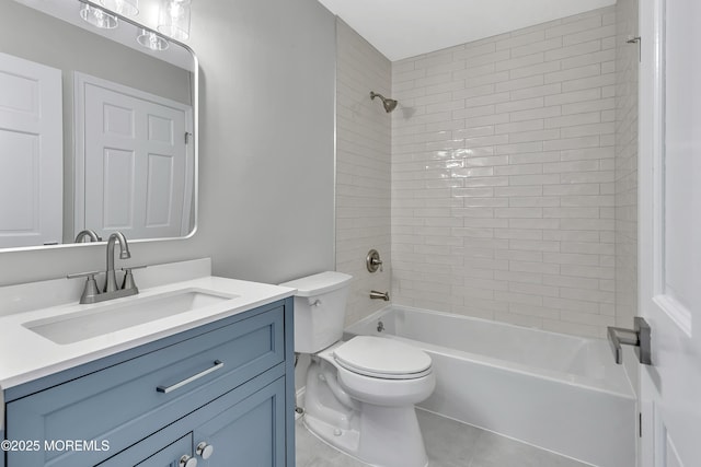 full bathroom featuring tile patterned flooring, tiled shower / bath, vanity, and toilet