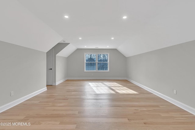 bonus room featuring vaulted ceiling and light hardwood / wood-style floors