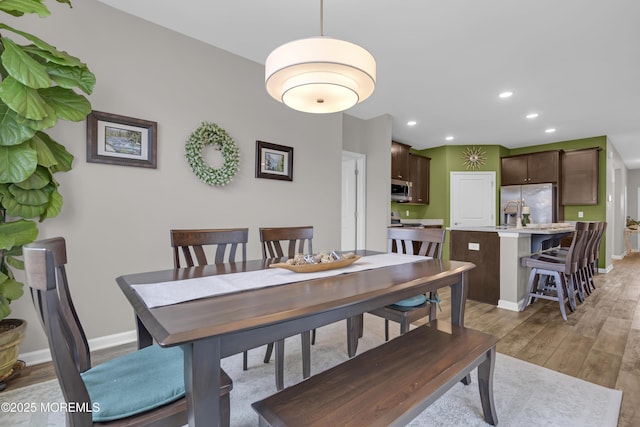 dining space featuring sink and hardwood / wood-style floors