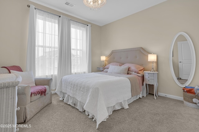 bedroom featuring light carpet and a chandelier