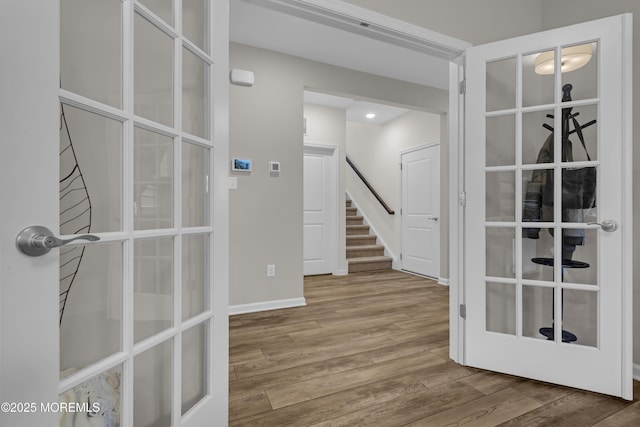 interior space with hardwood / wood-style flooring and french doors