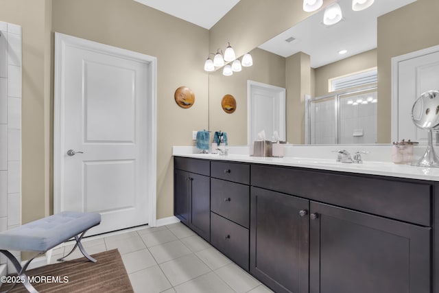 bathroom featuring tile patterned floors, a shower with shower door, and vanity