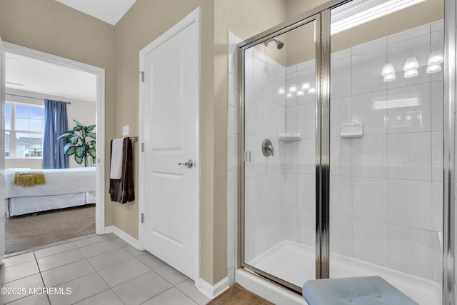 bathroom with walk in shower and tile patterned flooring