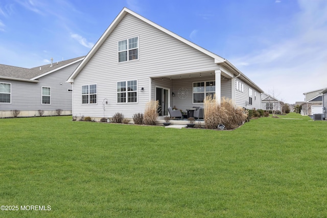 rear view of property featuring central AC unit and a lawn