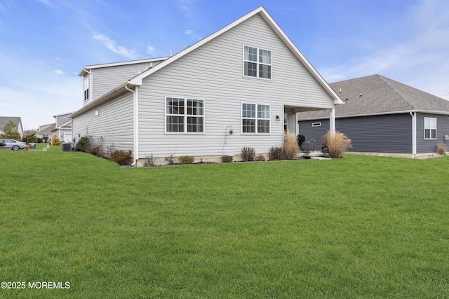 back of house featuring cooling unit and a lawn