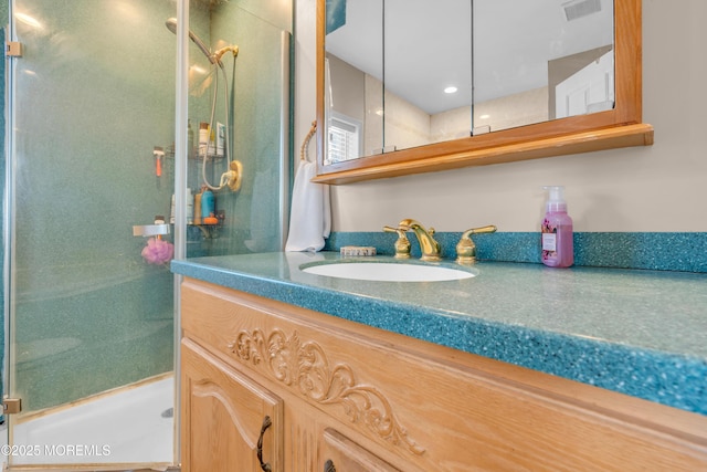 bathroom featuring vanity and tiled shower