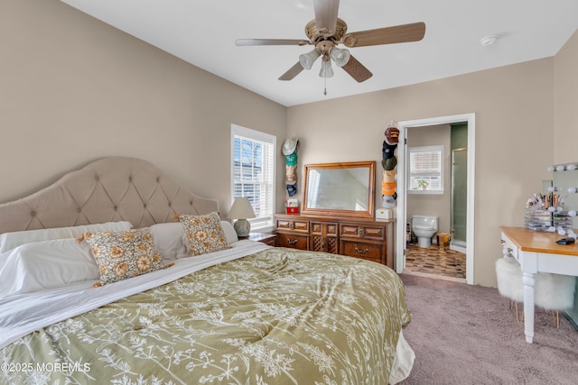 carpeted bedroom with ceiling fan and ensuite bath