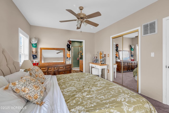 carpeted bedroom with connected bathroom, ceiling fan, and a closet