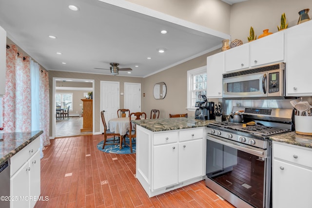 kitchen featuring stainless steel appliances and white cabinets