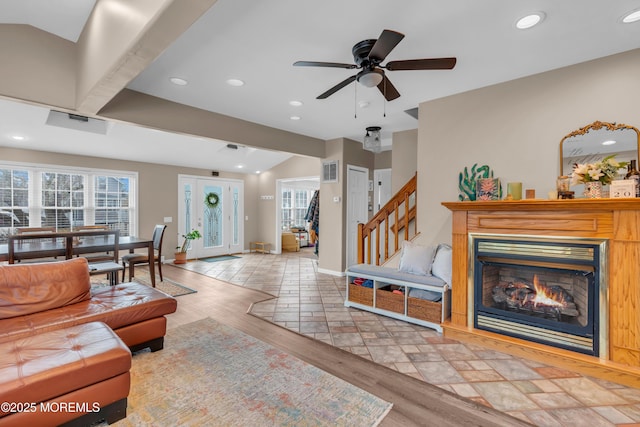 living room featuring lofted ceiling, plenty of natural light, and light hardwood / wood-style flooring