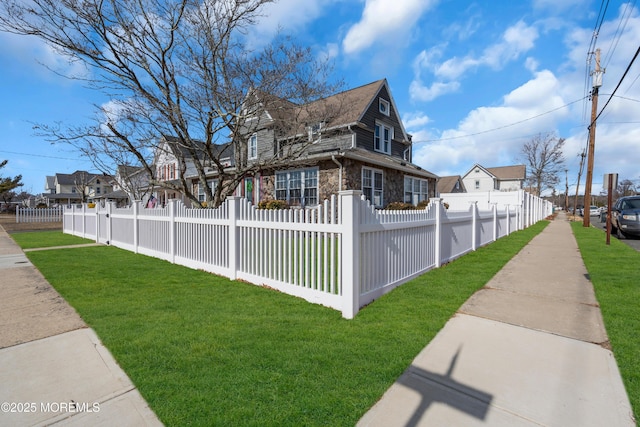 view of side of home featuring a yard