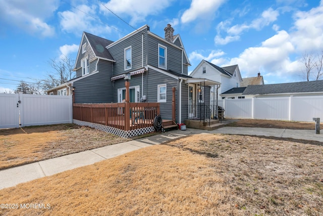 exterior space with a deck and a lawn