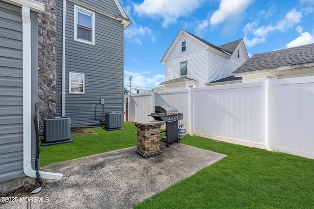 view of yard featuring a patio area and central air condition unit