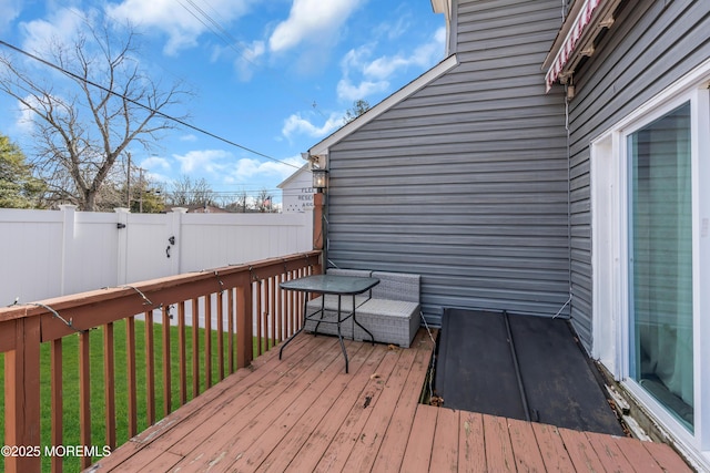 wooden terrace featuring a yard