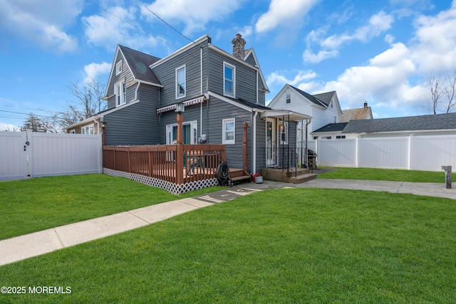 view of front of house with a wooden deck and a front lawn