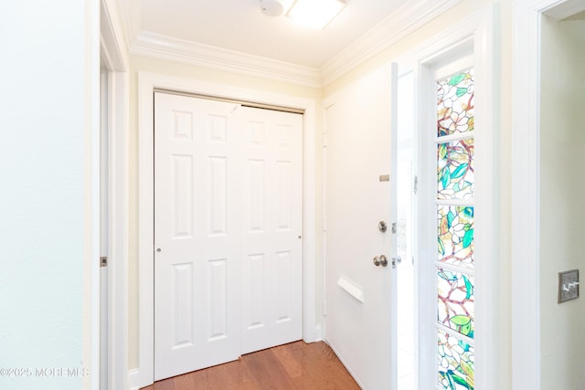 doorway featuring ornamental molding and wood-type flooring