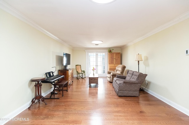 sitting room featuring hardwood / wood-style flooring and ornamental molding