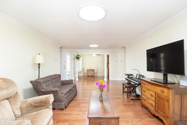 living room featuring ornate columns, ornamental molding, and light hardwood / wood-style flooring