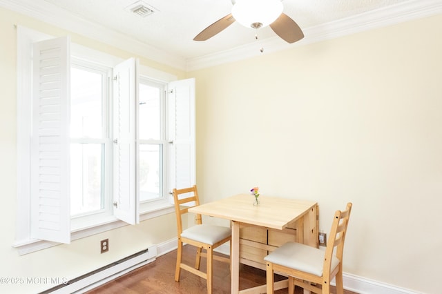 dining room featuring wood-type flooring, crown molding, ceiling fan, and baseboard heating