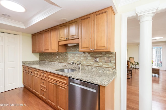 kitchen featuring sink, dishwasher, decorative columns, wood-type flooring, and ornamental molding