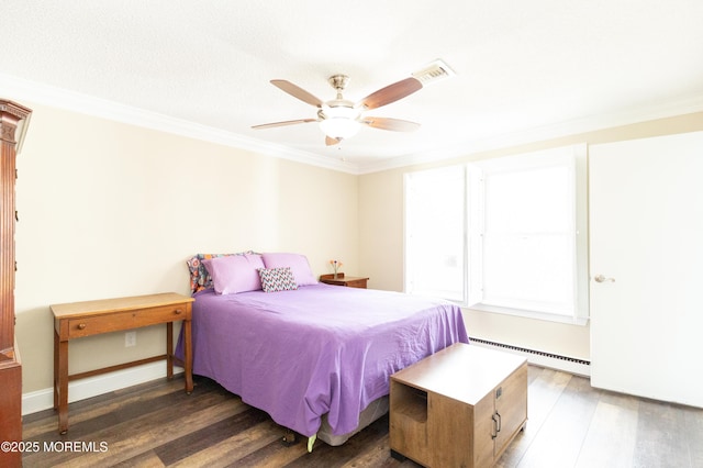 bedroom featuring dark wood-type flooring, ceiling fan, ornamental molding, and a baseboard heating unit