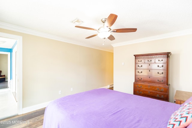 bedroom with hardwood / wood-style floors, ornamental molding, and ceiling fan