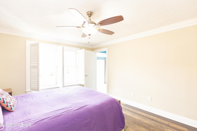 bedroom featuring crown molding, wood-type flooring, and a textured ceiling