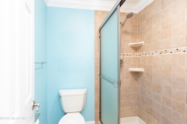 bathroom featuring crown molding, a shower with shower door, and toilet