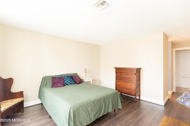 bedroom with dark hardwood / wood-style floors