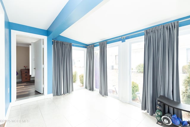 tiled spare room featuring a wealth of natural light