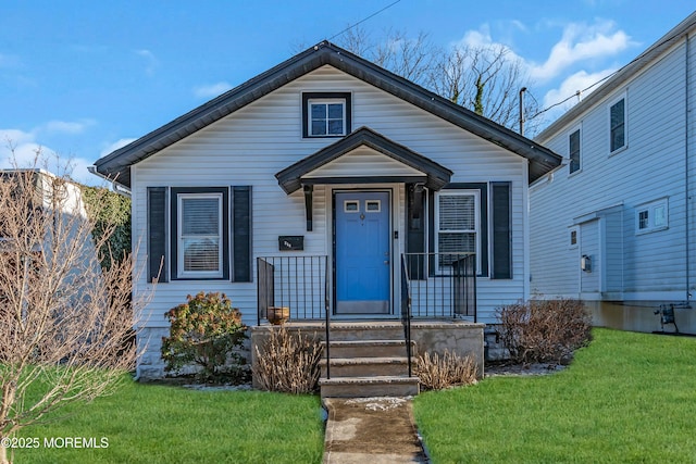 bungalow-style home with a front lawn